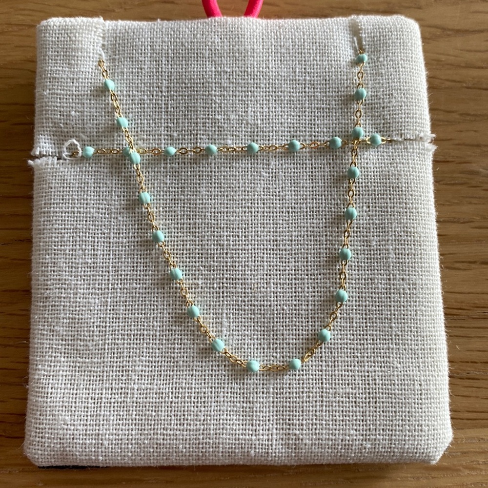 This necklace is by gigi CLOZEAU. This piece features 18 carat gold and resin.